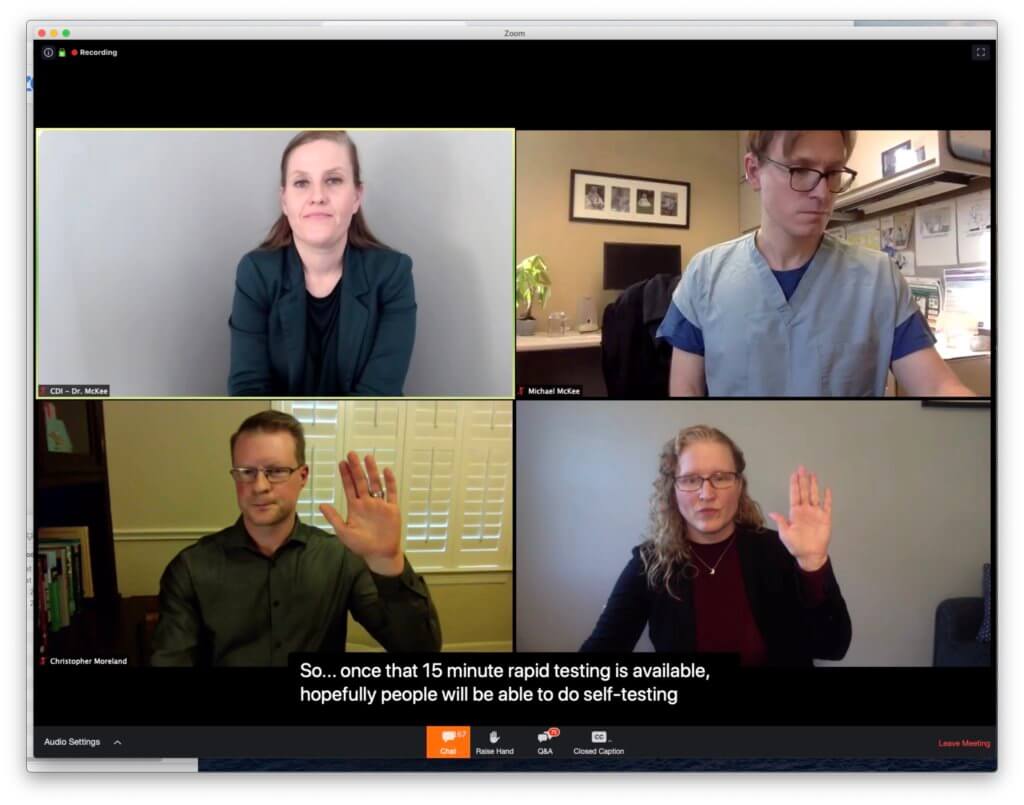 Panelist raising hand, with CDI mirroring. Four videos are visible, two of which show the signing panelists, and two of which show the CDIs shadowing the respective panelists. The videos are shown in a 2x2 grid. The bottom row shows the presenter and the CDI both raising their hands.